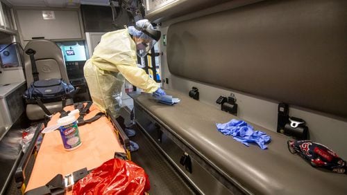 Paramedic Christopher Kozinski demonstrates how the truck would be sanitized after every call at the Central EMS office in Roswell, July 16, 2020.  STEVE SCHAEFER FOR THE ATLANTA JOURNAL-CONSTITUTION