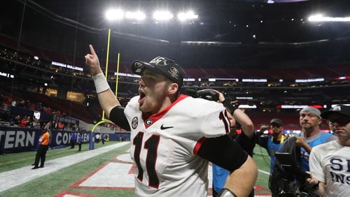 Georgia quarterback Jake Fromm (11) leaves the field after the Bulldogs won the SEC championship at Mercedes-Benz Stadium on Saturday.