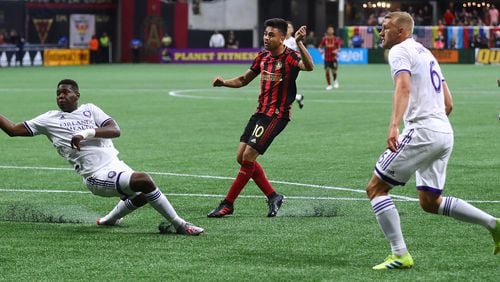 May 12, 2019 Atlanta: Atlanta United midfielder Pity Martinez scores his first goal of the season past Orlando City defenders in a MLS soccer match on Sunday, May 12, 2019, in Atlanta.  Curtis Compton/ccompton@ajc.com