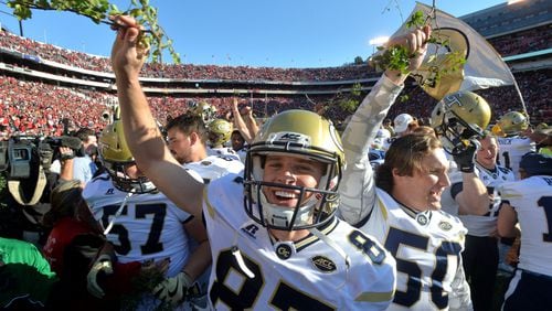 November 26, 2016 Athens - Georgia Tech place kicker Harrison Butker (87) and other players celebrate their 28-27 win over Georgia with a piece of the Sanford Stadium hedges at Sanford Stadium on Saturday, November 26, 2016. HYOSUB SHIN / HSHIN@AJC.COM