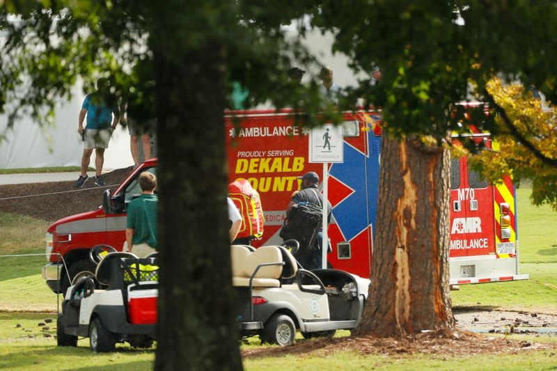 ATLANTA, GEORGIA - AUGUST 24:  Emergency services provide assistance next to a tree damaged by a lightning strike during a suspension in play of the third round of the TOUR Championship at East Lake Golf Club on August 24, 2019 in Atlanta, Georgia. (Photo by Kevin C. Cox/Getty Images)