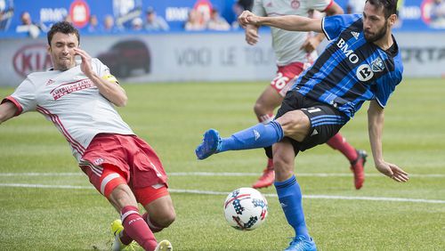 Montreal Impact's Matteo Mancosu, right, takes a shot as Atlanta United's Michael Parkhurst defends during second half MLS soccer action in Montreal, Saturday, April 15, 2017. (Graham Hughes/The Canadian Press via AP)