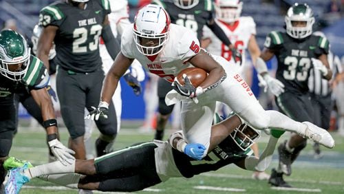 December 11, 2021 - Atlanta, Ga: Milton running back Jordan McDonald (5) is tackled by Collins Hill defensive back Jayden Davis (7) during the second half of the Class 7A state title football game at Georgia State Center Parc Stadium Saturday, December 11, 2021, Atlanta. Collins Hill won 24-8. JASON GETZ FOR THE ATLANTA JOURNAL-CONSTITUTION



