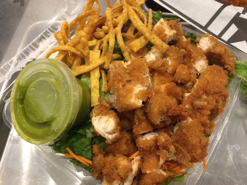 Ponko Chicken’s meal-size salad comes with choice of protein and dressing and is shown here with chopped original chicken tenders and the walnut-cilantro salad. CONTRIBUTED BY WENDELL BROCK