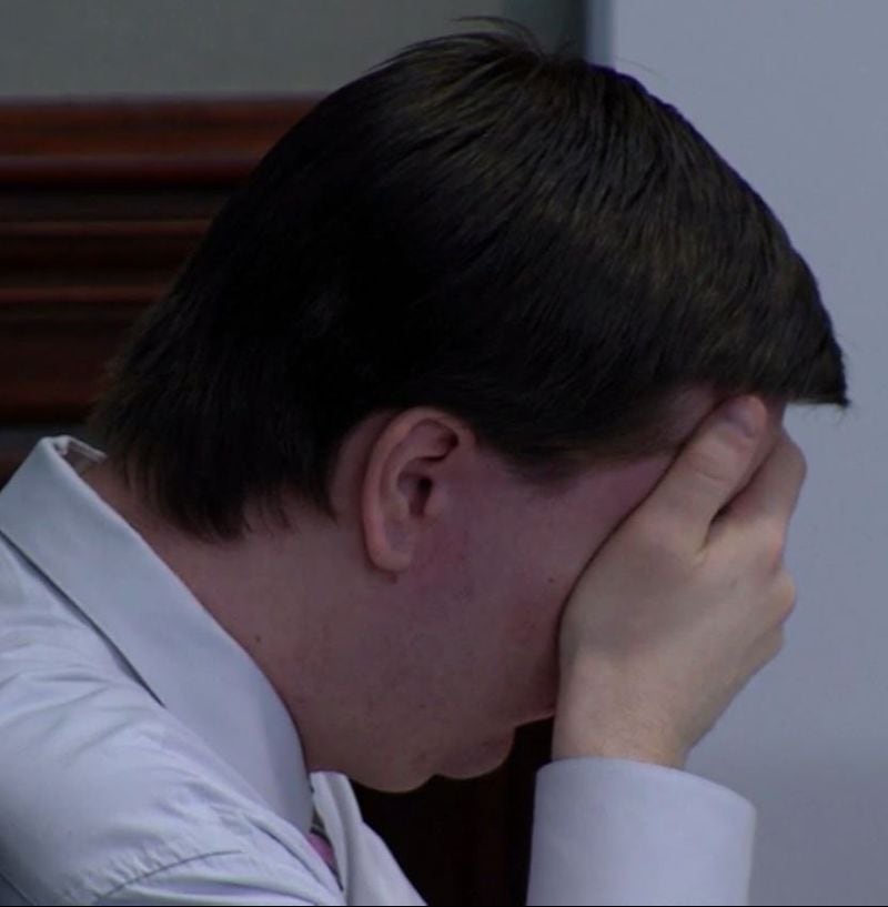Justin Ross Harris covers his eyes while the prosecutor shows images of his dead son Cooper on a large screen for jurors, during Harris' murder trial at the Glynn County Courthouse in Brunswick, Ga., Wednesday, Oct. 5, 2016. (screen capture via WSBTV)