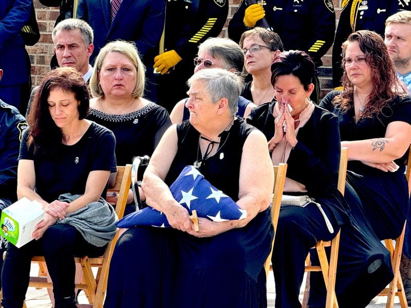 Elizabeth Connolly, the mother of slain correctional officer Robert Clark, holds a folded American flag at her son's funeral. (Lewis Levine)