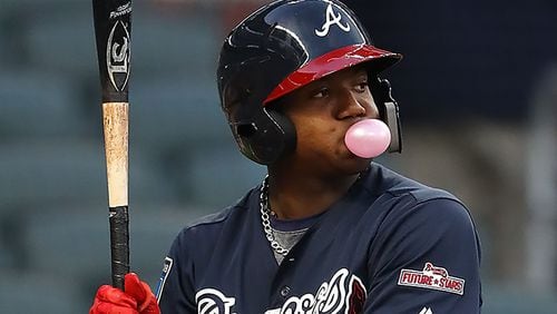 Braves outfielder Ronald Acuna Jr., blows a bubble while he bats during the first inning in the Future Stars Exhibition Game Tuesday, March 27, 2018, at SunTrust Park.