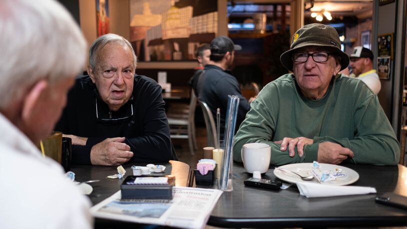 Don Kittle, from left, Luther Goforth and Don Pelfrey talk politics over breakfast and coffee at the Oakwood Cafe in Dalton. They are divided on whether U.S. Rep. Marjorie Taylor Greene is fit to serve in the U.S. House. Ben Gray for the Atlanta Journal-Constitution