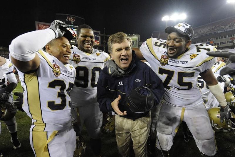 Georgia Tech coach Paul Johnson celebrates with his players (left to right) Michael Peterson, T.J. Barnes, and Nick Claytor after winning the ACC championship on Saturday, Dec. 5, 2009 in Tampa, Fla. Johnny Crawford/AJC file