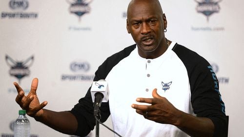 In this file photo, Charlotte Hornets owner Michael Jordan responds to a question during a news conference on Oct. 28, 2014, at Time Warner Cable Arena in Charlotte, North Carolina. Jordan and NASCAR driver Denny Hamlin are starting a NASCAR team, with Bubba Wallace behind the wheel. (Jeff Siner/The Charlotte Observer/TNS)
