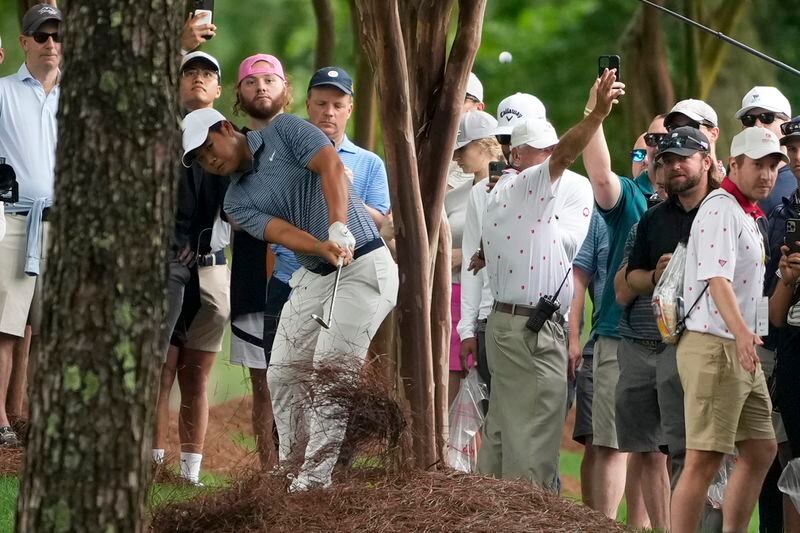 Tom Kim, of South Korea, hits from the pine straw on the second hole first round of the Wells Fargo Championship golf tournament at the Quail Hollow Club Thursday, May 9, 2024, in Charlotte, N.C. (AP Photo/Chris Carlson)