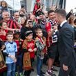 Atlanta United defender Brooks Lennon, right, greets fans as the team arrives before their MLS home opener against the New England Revolution at Mercedes-Benz Stadium, Saturday, March 9, 2024, in Atlanta. (Jason Getz / jason.getz@ajc.com)