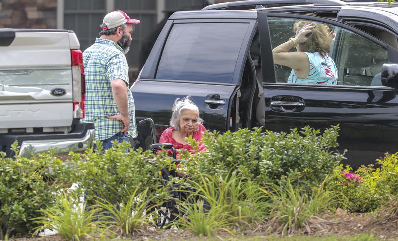 On Friday, July 16, 2021, the last resident of Tranquil Gardens Assisted Living and Memory Care is helped into a vehicle, after the owners abruptly informed residents and workers they were closing. (John Spink / John.Spink@ajc.com)