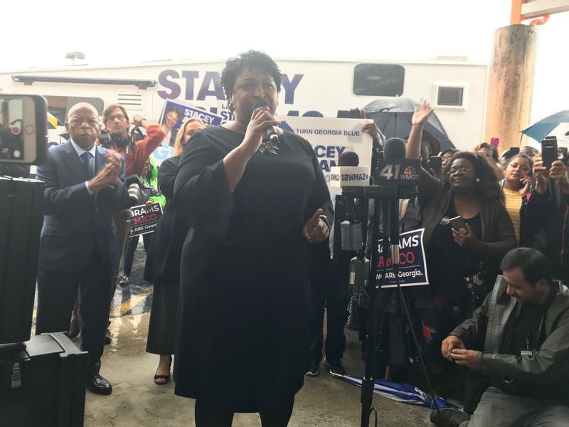 Stacey Abrams, shown campaigning for governor in 2018 with U.S. Rep. John Lewis standing behind her, said he taught her to focus — not just on winning but on doing good. “What was so telling about John Lewis is that he never apologized for his partisanship, but he also never allowed it to sublimate his sense of citizenship,” she said. “And that is what I hope I continue to reflect.” (TIA MITCHELL/TIA.MITCHELL@AJC.COM)