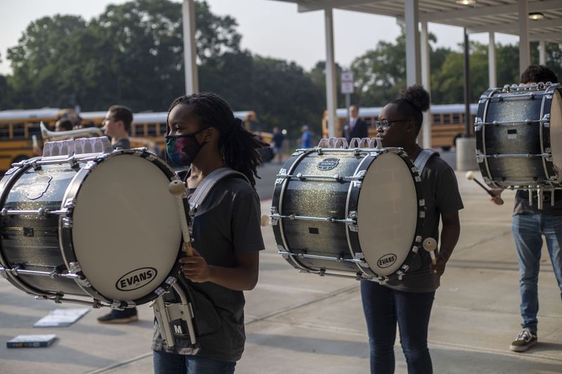 Members of the Campbell High School marching band welcome Pearson Middle School students with a performance during the first day of school at Pearson Middle School in Marietta, Monday, August 2, 2021. (Alyssa Pointer/Atlanta Journal Constitution)