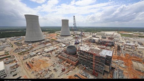 The cooling towers for Plant Vogtle reactors 3 and 4 rise above the construction sites. GEORGIA POWER