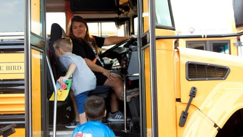 A Cobb County School District bus driver picks up students at Picketts Mill Elementary School.