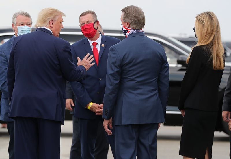 U.S. Rep. Doug Collins, red mask, and U.S. Sen. Kelly Loeffler, far right, have been locked in battle for months looking for leverage in Georgia's special election for Loeffler's seat. They have lobbied hard for the support of President Donald Trump, who so far has avoided backing either one at the expense of the other. Curtis Compton ccompton@ajc.com