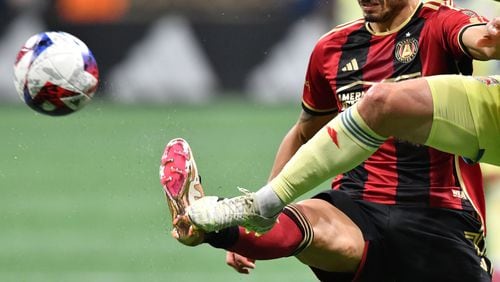 Atlanta United's forward Giorgos Giakoumakis (7) is kicked by New York Red Bulls' defender Dylan Nealis (right) as they fights for the ball during the second half in a MLS soccer match at Mercedes-Benz Stadium, Saturday, April 1, 2023, in Atlanta. Atlanta United won 1-0 over New York Red Bulls. (Hyosub Shin / Hyosub.Shin@ajc.com)