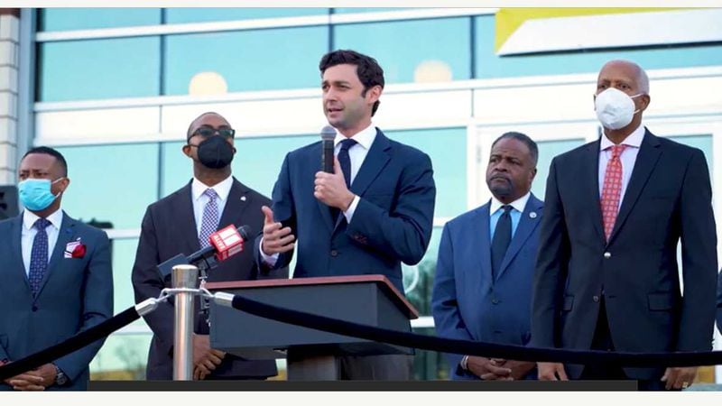 U.S. Sen. Jon Ossoff, D-Ga., holding the microphone, speaks during an event on Nov. 22, 2021, outside the Atlanta University Center Robert W. Woodruff Library about legislation to provide cybersecurity training funds to historically Black colleges and universities. (Courtesy of U.S. Sen. Jon Ossoff's office)