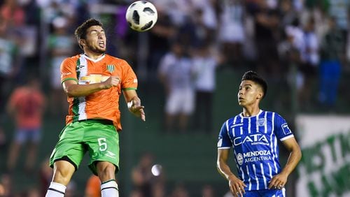 Eric Remedi of Banfield heads the ball against Guillermo FernÃ¡ndez of Godoy Cruz during a match between Banfield and Godoy Cruz as part of Argentina Superliga 2017/18 at Florencio Sola Stadium on April 21, 2018 in Buenos Aires, Argentina. (Photo by Marcelo Endelli/Getty Images)