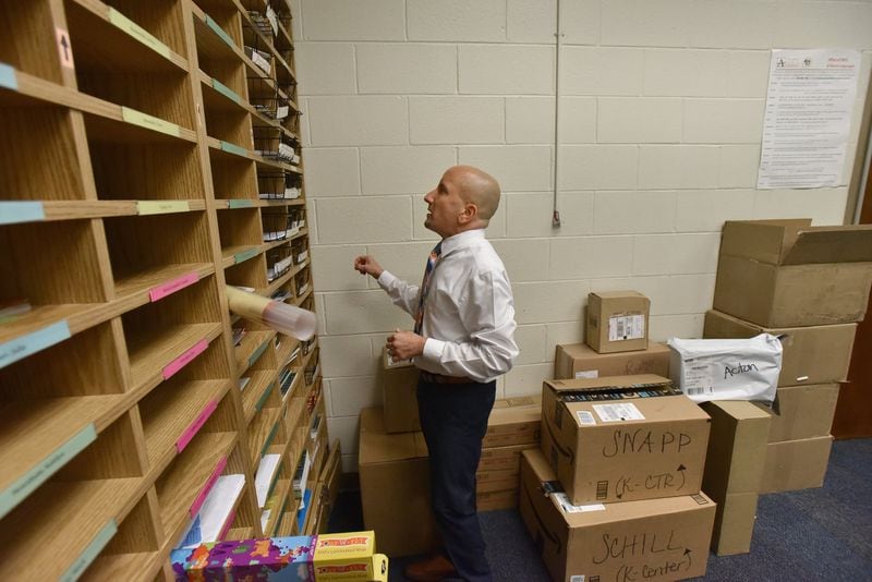 School Business Manager Brian Baron handles some paper works related to the parent-teacher association at the main office of Morningside Elementary School on Friday, September 28, 2018. HYOSUB SHIN / HSHIN@AJC.COM