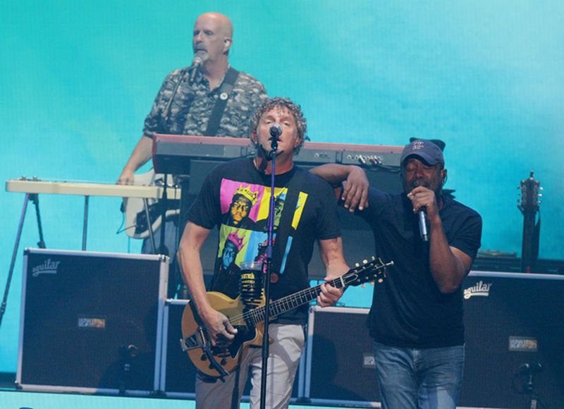 Hootie & The Blowfish's Mark Bryan (left) and Darius Rucker share a bro moment during their June 1 sold-out show at Cellairis Amphitheatre at Lakewood. Photo: Melissa Ruggieri/Atlanta Journal-Constitution