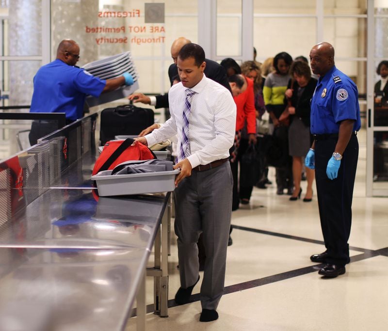 Nov. 23, 2015 - Atlanta - Airport employee Tony O'brien leads the line through security in a timed test to show how possession of prohibited items delays the line. TSA personnel demonstrated how they respond to prohibited items at security checkpoints in a session for the press using airport employees playing the part of passengers. The Transportation Security Administration is advising travelers to keep prohibited items out of their bags to keep security lines moving. At Hartsfield-Jackson Atlanta International Airport, more than 130 people have been caught with guns at airport security checkpoints so far this year. Whenever a gun, explosive or other dangerous weapons are caught at checkpoints, TSA officers halt security screening in the lane and call Atlanta police to respond to the checkpoint. BOB ANDRES / BANDRES@AJC.COM