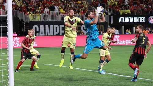 August 14, 2019 Atlanta: Atlanta United goalkeeper Alec Kann blocks a shot by Club America in front of Bruno Valdez during the first half in the Campeones Cup on Wednesday, August 14, 2019, in Atlanta.   Curtis Compton/ccompton@ajc.com