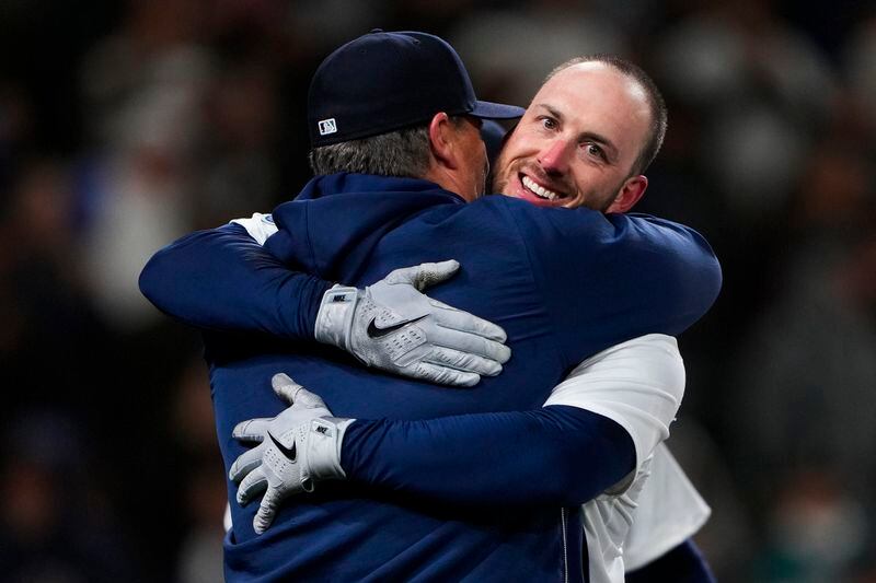Seattle Mariners designated hitter Mitch Garver, right, hugs manager Scott Servais after hitting a two-run walk-off home run against the Atlanta Braves during the ninth inning of a baseball game Monday, April 29, 2024, in Seattle. The Mariners won 2-1. (AP Photo/Lindsey Wasson)
