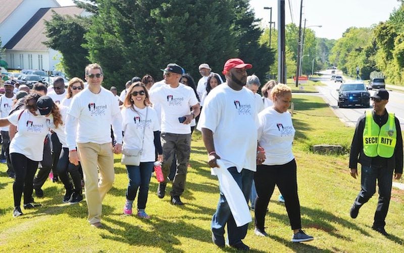 Marriage counselors Martez Layton in red cap with his wife Woodrina lead the way as couples join them in their annual Married 4 Life Walk, held each year to encourage couples and prevent divorce. CONTRIBUTED