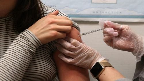 Stock photo of a flu vaccine being administered.
