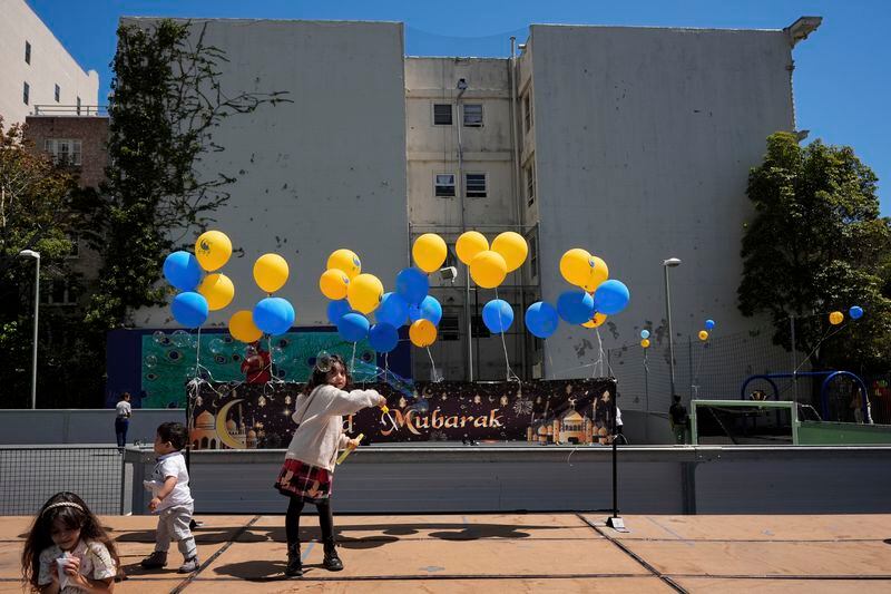 Six-year-old Leen Najjar, center, plays with a bubble-maker during an Eid celebration at the Tenderloin Recreation Center, Saturday, April 20, 2024, in San Francisco. (AP Photo/Godofredo A. Vásquez)