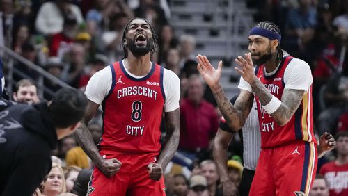 New Orleans Pelicans forward Naji Marshall (8) reacts with forward Brandon Ingram after a turnover in the second half of an NBA basketball play-in tournament game against the Sacramento Kings in New Orleans, Friday, April 19, 2024. The Pelicans won 105-98. (AP Photo/Gerald Herbert)