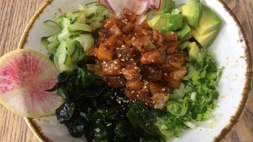 The poke bowl at Momonoki comes with a mixture of bluefin tuna, salmon and yellowtail, plus avocado, scallions, radishes, pickled daikon, and pickled cucumber. CONTRIBUTED BY WENDELL BROCK
