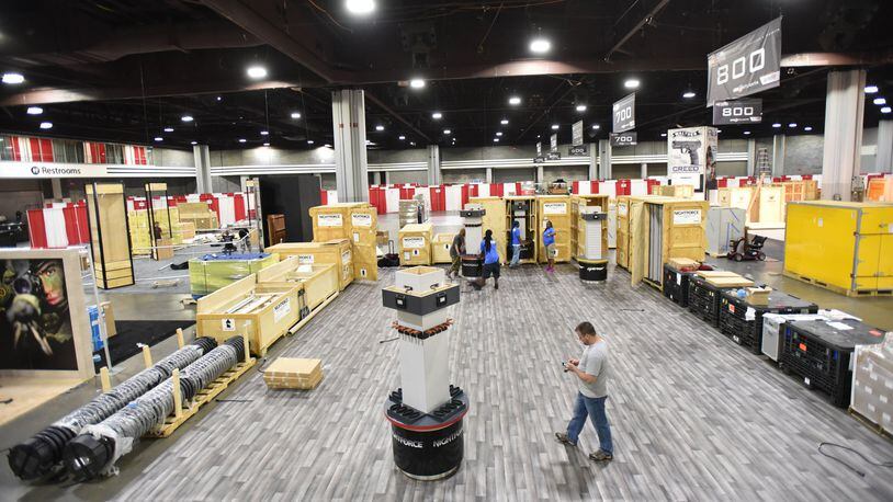 Workers put the finishing touches on the convention floor at the Georgia World Congress Center in preparation for The 146th NRA Annual Meetings and Exhibits in Atlanta. More than 80,000 people are set to attend the NRA convention, which kicks off in Atlanta on Thursday evening and continues through Sunday. HYOSUB SHIN / HSHIN@AJC.COM