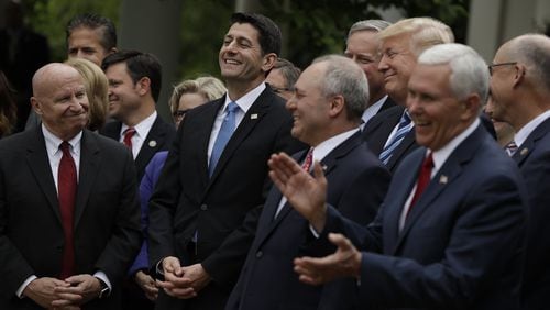U.S. House Speaker Paul Ryan of Wisconsin — flanked by House Ways and Means Committee Chairman Kevin Brady, R-Texas, and House Majority Whip Steve Scalise of Louisiana — smiles as President Donald Trump speaks in the Rose Garden of the White House in Washington on May 4 after the House pushed through a health care bill. (AP Photo/Evan Vucci)