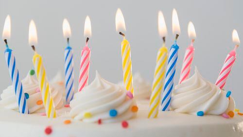 Studio shot of birthday cake with lit candles (stock photo)