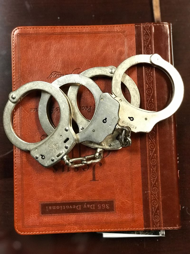 The handcuffs used to arrest two suspects in the killing of Timothy Coggins 34 years ago. Spalding County Sheriff Darrell Dix plans to give them to the original investigators on the case. ROSALIND BENTLEY/AJC