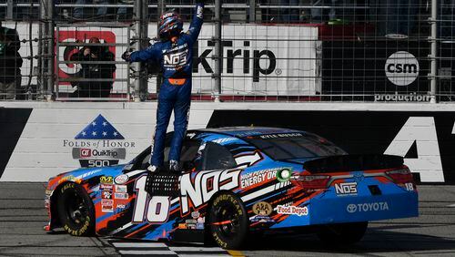 Kyle Busch celebrates at the finish line after winning a NASCAR Xfinity auto race at Atlanta Motor Speedway in Hampton, Ga., Saturday, March 4, 2017. (AP Photo/John Amis)