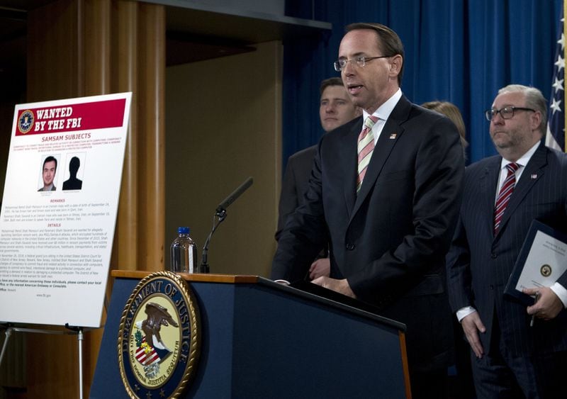 Deputy Attorney General Rod Rosenstein speaks during a news conference announcing the indictment against international computer hackers, at the Department of Justice in Washington, Wednesday, Nov. 28, 2018. The Justice Department says two Iranian computer hackers have been charged in connection with multimillion-dollar cybercrime and extortion scheme that targeted U.S. government agencies and businesses. (AP Photo/Jose Luis Magana)
