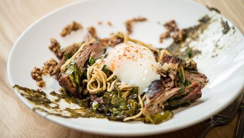 Cast Iron’s rye spaghetti with pork shoulder, collard greens, poached egg, mustard seeds and burnt onion is better some times than others. CONTRIBUTED BY MIA YAKEL