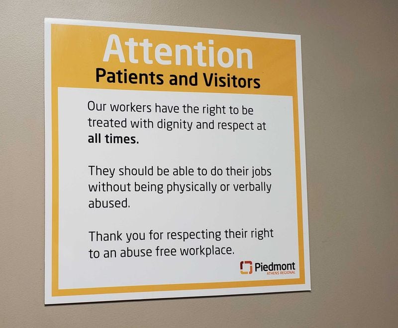 A sign, one of many posted at Piedmont Athens Hospital, reminds visitors not to abuse the nursing staff. (Jennifer Peebles / AJC staff)