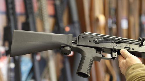 A bump stock, (left) that fits on a semiautomatic rifle to increase the firing speed, making it similar to a fully automatic rifle, is installed on an AK-47 at a gun store on October 5, 2017 in Salt Lake City, Utah. Congress is talking about banning this device after it was reported to have been used in the Las Vegas shootings on Oct. 1. (Photo by George Frey/Getty Images)