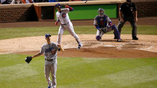 Chicago Cubs' Javier Baez watches his home run off Los Angeles Dodgers starting pitcher Alex Wood (57) during the fifth inning of Game 4 of baseball's National League Championship Series, Wednesday, Oct. 18, 2017, in Chicago. (AP Photo/Charles Rex Arbogast)