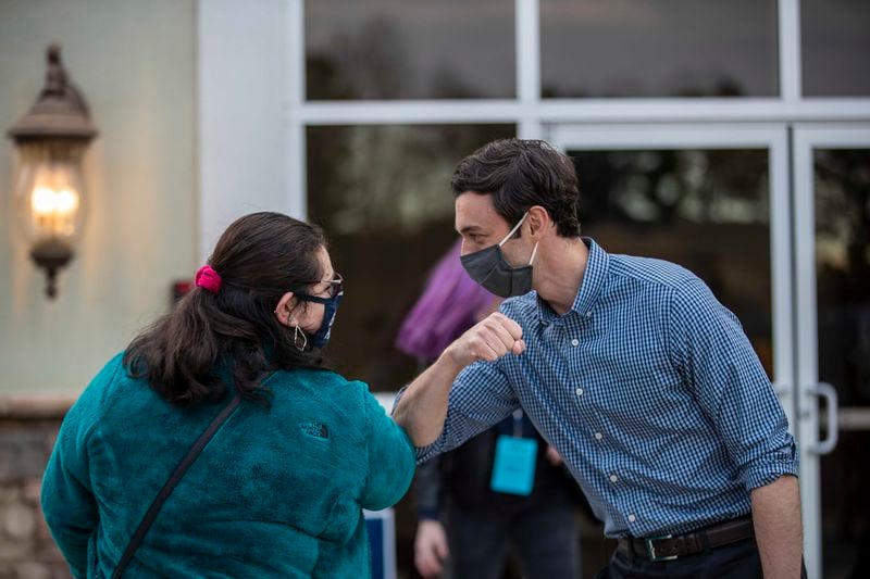 Democratic U.S. Senate candidate Jon Ossoff taps elbows with Kennesaw State University student Samantha Best following a rally Thursday in the parking lot of Grace Community Christian Church in Kennesaw. “The bottom line is that victory in Georgia comes down to young people,” Ossoff said at the rally. (Alyssa Pointer / Alyssa.Pointer@ajc.com)