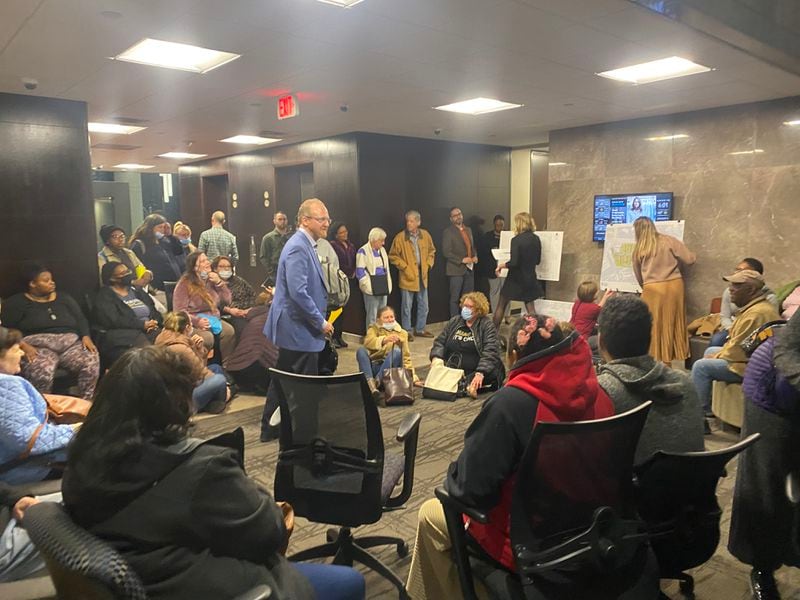 The builder planning to redevelop a Sandy Springs plaza into mixed-use was pressed by residents crowded into an office lobby during its first community meeting Monday. Credit: Adrianne Murchison