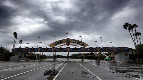 Disney, along with Universal and SeaWorld, are closing their Central Florida parks this week in response to Tropical Storm Nicole. Just a few weeks ago, Hurricane Ian prompted closures as well. Here, clouds from Ian are seen over the entrance to the Magic Kingdom at Walt Disney World on Sept. 28, 2022. (Joe Burbank/Orlando Sentinel/TNS)