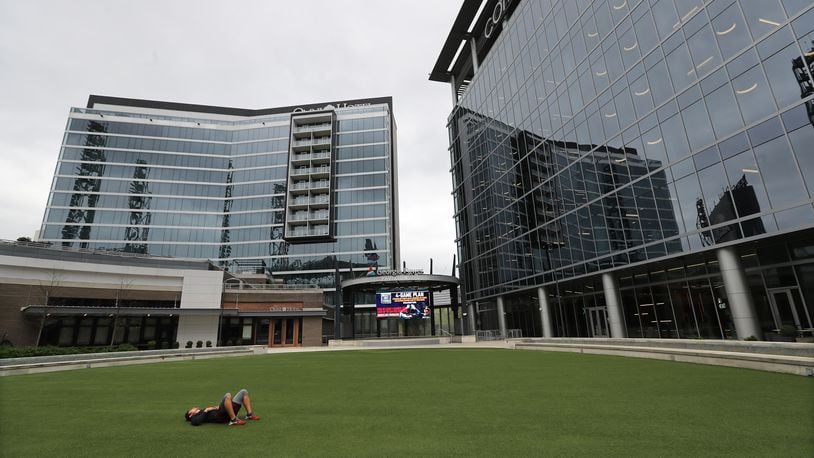 March 31, 2020 Atlanta: Battery resident Dalton Becker has the Georgia Power Pavilion area all to himself to take a break from exercising outside the Omni Hotel and Comcast building at Truist Park on Tuesday, March 31, 2020, in Atlanta. Curtis Compton ccompton@ajc.com