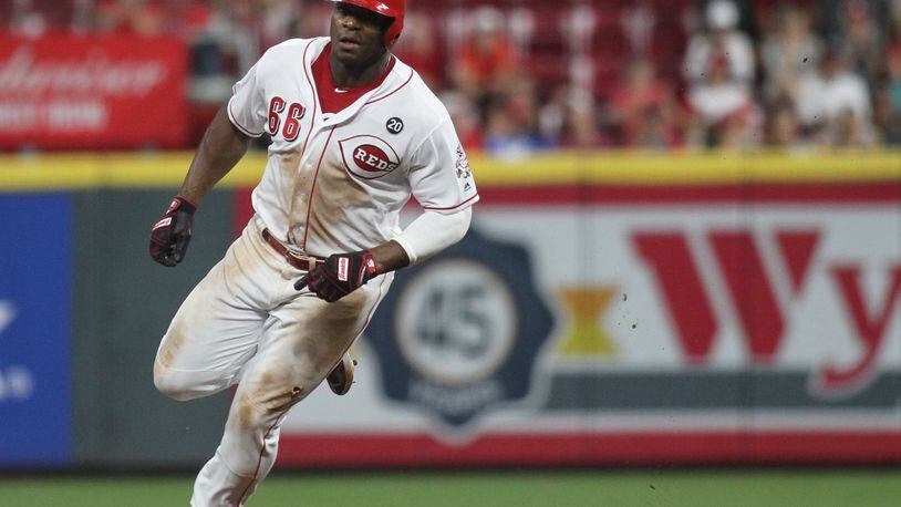 The Reds’ Yasiel Puig rounds the bases on his way to scoring the winning run in the 11th inning against the Brewers on Tuesday, July 2, 2019, at Great American Ball Park in Cincinnati. David Jablonski/Staff